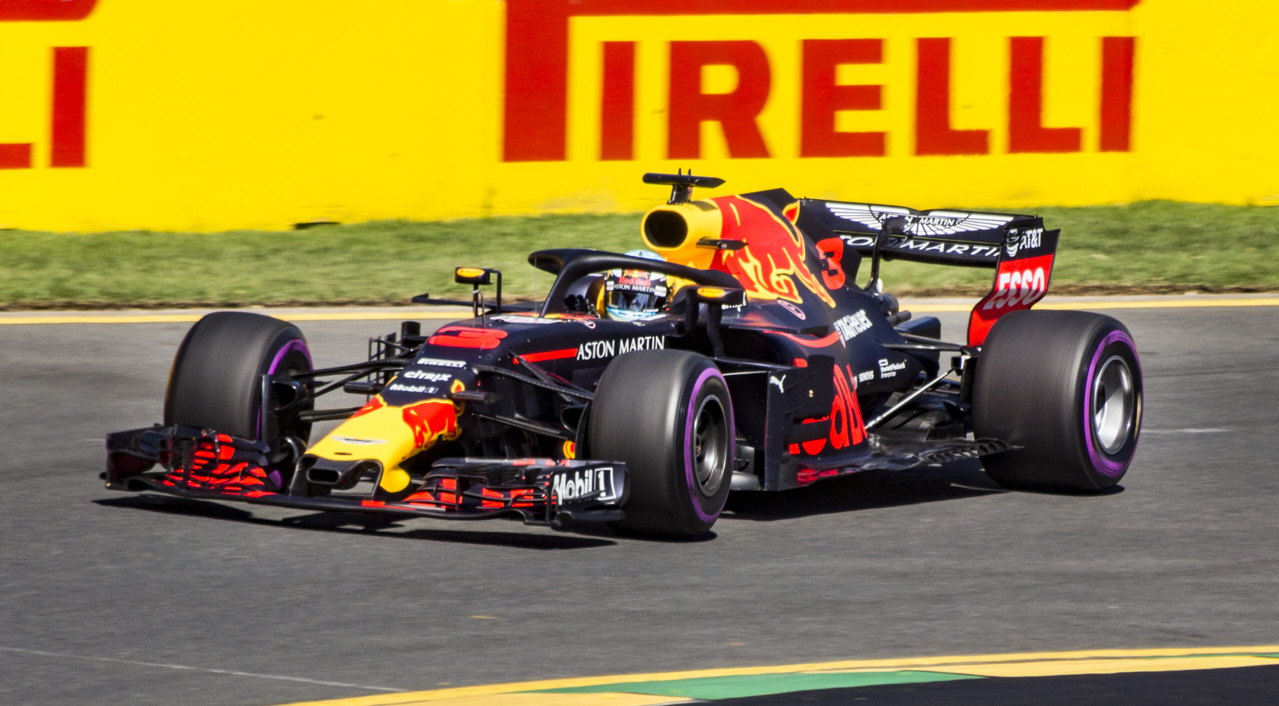 Formula 1 car on track beside Pirelli advertising boards